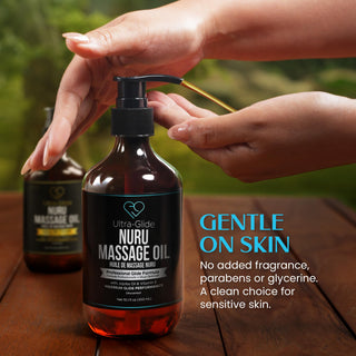 Hand pressing the pump on a Nuru Massage Oil bottle: no added fragrance, parabens or glycerine